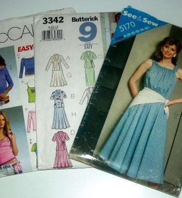 "Assorted vintage and contemporary sewing patterns including McCall's, Butterick, and See & Sew desi