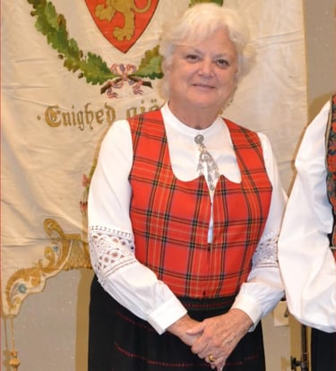 a woman in a red plaid festdrakt with a solje