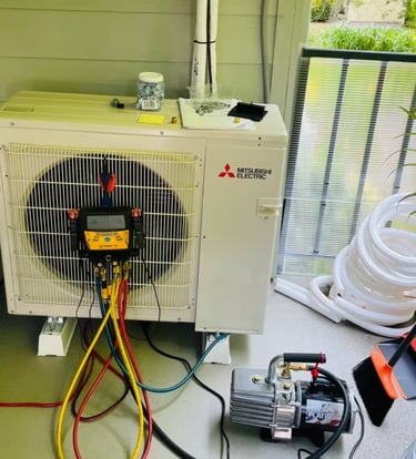Engineer doing annual maintenance checks and readings on an Ac System on a balcony