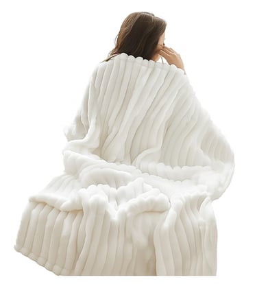 A ultra-soft cream-colored faux fur throw blanket folded and draped, showing its fluffy texture