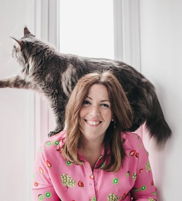 photo of gabi smiling at the camera with her maine coone cat 