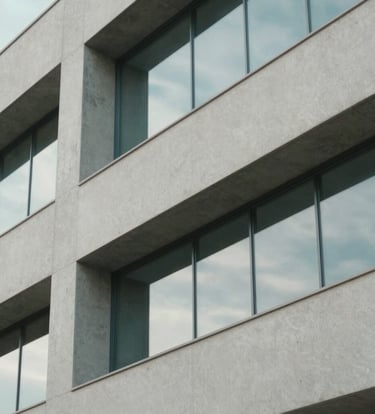 Close-up of modern Brazilian architectural details, clean lines of concrete and glass, soft natural light with reflections of baby blue sky. Minimalist and professional composition with light gray tones.