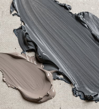 Close-up macro photography of charcoal grey and taupe oil paint textures on a linen canvas. The light is soft and directional, highlighting the organic peaks of the medium. North American contemporary style.
