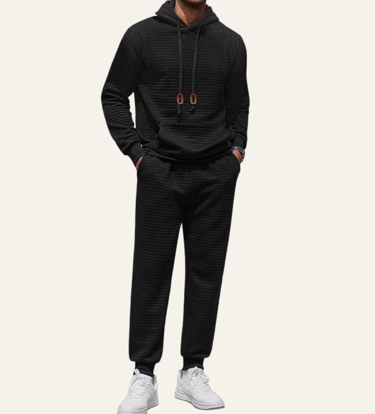 picture of the body of a man wearing a black matching hoodie and jogger set