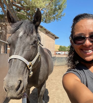Jess with a horse she works with.