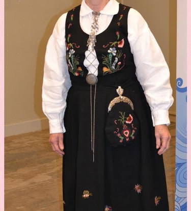 A woman in a blue embroidered bunad