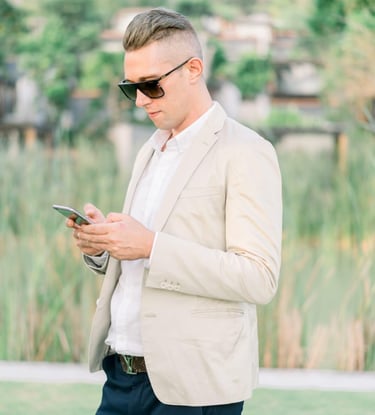Francesco Margaretini Luxury Travel Villas Weddings working on the mobile phone