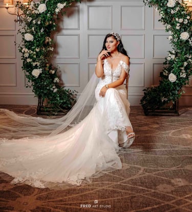 Bride posing under floral arch in wedding gown – Oxford wedding photography by Fred Art Studio