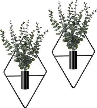 Set of two wall-mounted black geometric diamond vases with artificial eucalyptus greenery for modern home decor.