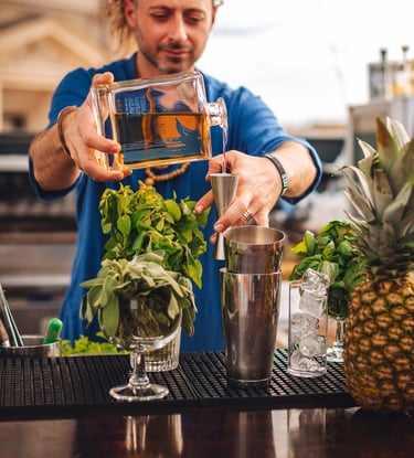 a man is making a tequila cocktail with a bottle of uno tequila añejo - premium tequila añejo