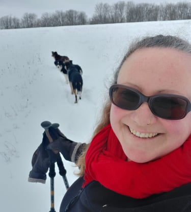 Image of Anne snowshoeing wit dogs. 