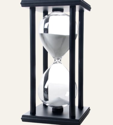 picture of an hourglass in a black fixture with white sand