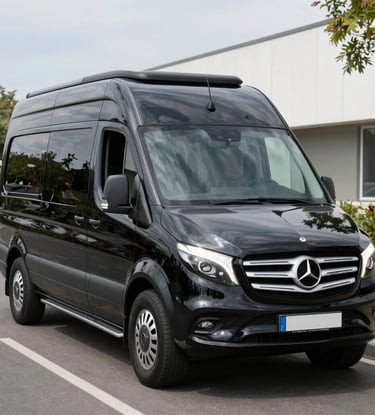 A sleek black luxury sedan parked in front of a modern Toronto skyline at dusk.