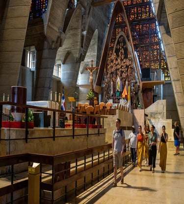 Tourists walking through the modern interior of Basilica of Our Lady of Altagracia in Higuey.