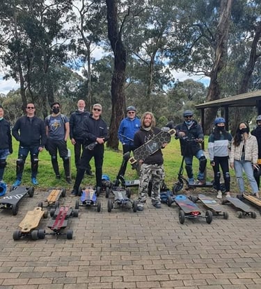 group of guys with electric skateboards having fun riding