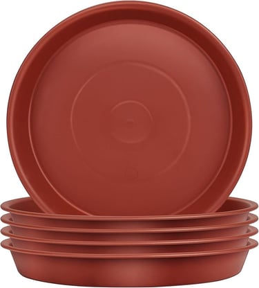 a stack of three red plates with a bowl of food