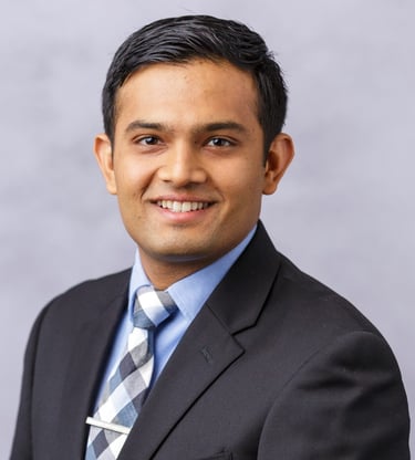 a man in a suit and tie smiling