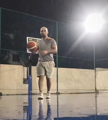 a man holding a basketball ball on a basketball court