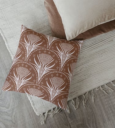 a pillow with a brown and beige seamless nature pattern design Bali inspiration