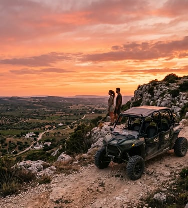 Couple beside off-road buggy on rocky ridge with panoramic Valle d'Itria sunset view