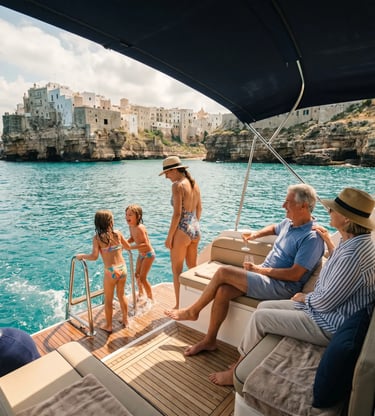 Family with kids and grandparents enjoying yacht deck with Polignano a Mare old town backdrop
