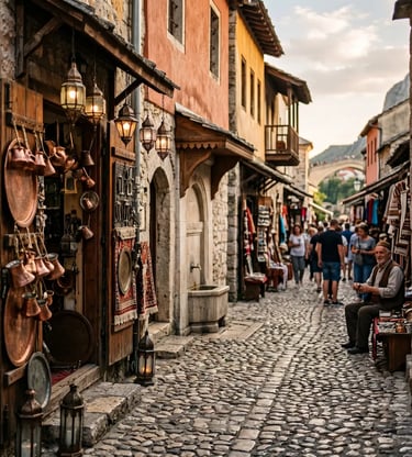 Cobblestone bazaar street in Mostar old town with copper coffee pots, lanterns and Old Bridge in view