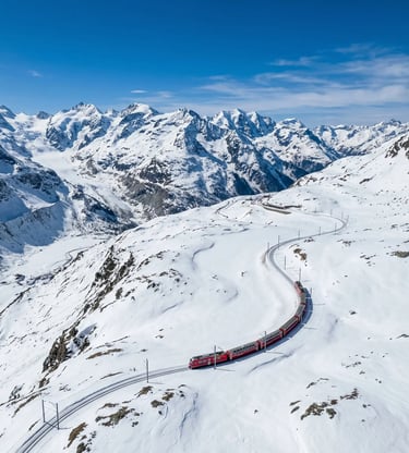 Aerial view of red Bernina Express winding through snow-covered Swiss Alpine landscape