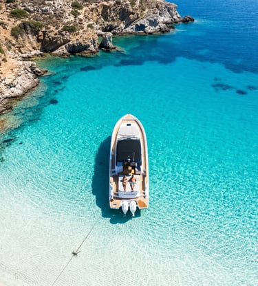 Premium speedboat cruising toward Kleftiko white volcanic cliffs in Milos at golden hour sunset