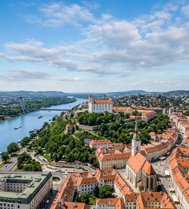 Drone shot of Bratislava Castle on a hill overlooking the Danube River