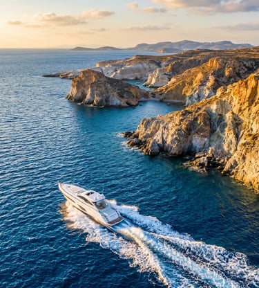 Aerial view of luxury speedboat cruising along the volcanic cliffs of Milos at golden hour