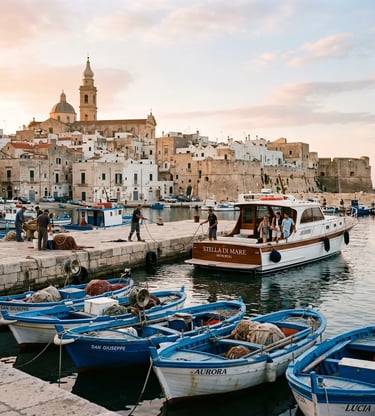 Historic Monopoli old port at sunrise with blue fishing boats and whitewashed Apulian old town