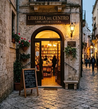 Warm lit bookstore entrance on a cobblestone street in Bari old town at dusk