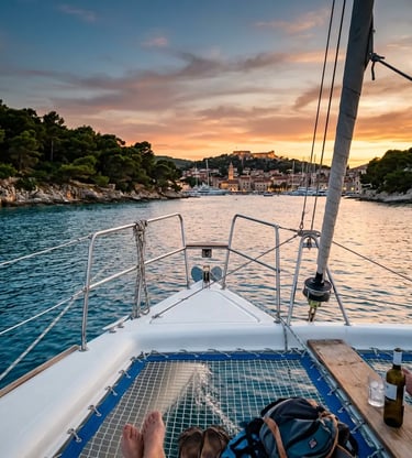 Catamaran bow view approaching Hvar town and Pakleni Islands at sunset Croatia