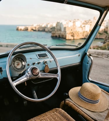 Sky-blue vintage Fiat 500 Spiaggina dashboard and straw hat with Polignano coastline in background