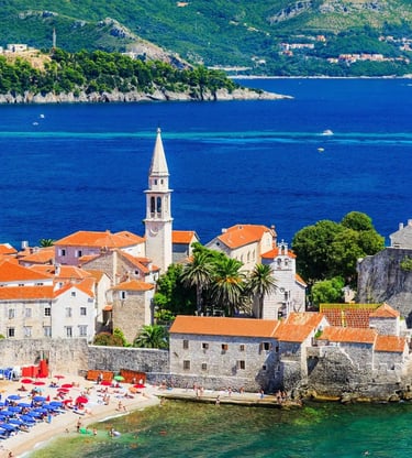 Aerial view of Budva medieval old town with orange rooftops and turquoise Adriatic sea