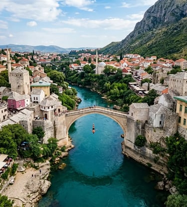 Diver jumping from Stari Most bridge into turquoise Neretva River in Mostar