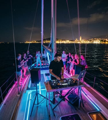 DJ performing live set on private sailboat deck during Split boat party at night