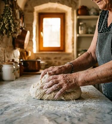Elderly Italian woman kneading bread dough on marble counter in a traditional Bari stone kitchen