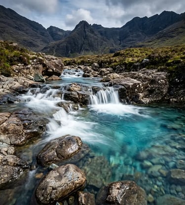  Crystal clear turquoise Fairy Pools with cascading water and Black Cuillin Mountains behind