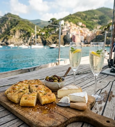  Ligurian focaccia, cheese, olives, and prosecco served on a boat deck with Cinque Terre village behind