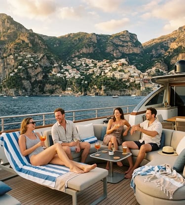 Guests enjoying drinks on a luxury yacht sundeck with Amalfi Coast village in the background