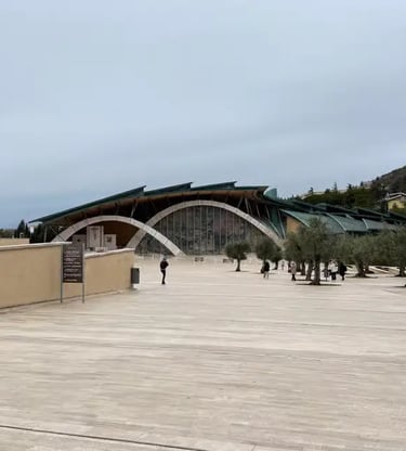 Padre Pio Pilgrimage Church exterior San Giovanni Rotondo with stone cross and olive trees