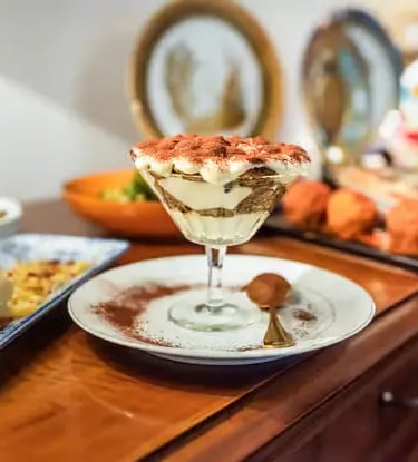 Homemade tiramisu in glass dusted with cocoa served during Lecce pasta and dessert class