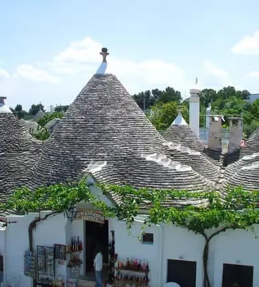 Historic stone trulli houses with conical roofs in Alberobello UNESCO site, Puglia Italy