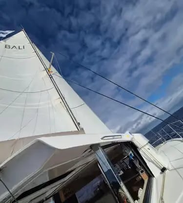 Bali catamaran under full sail with blue sky on Mediterranean sailing holiday
