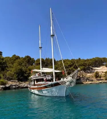 Luxury Gulet anchored in a secluded turquoise cove near Brač island, Croatia