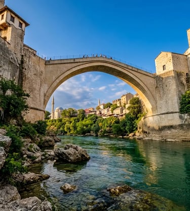 Stari Most bridge in Mostar seen from below with emerald Neretva River and old town beyond