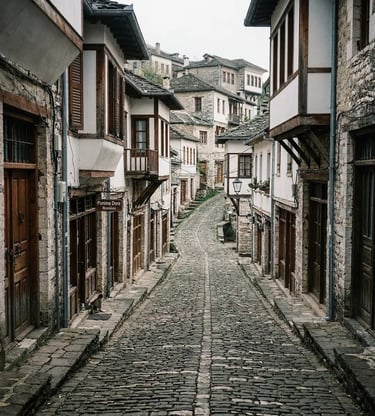 Empty cobblestone alley lined with Ottoman stone houses in Gjirokastër old town Albania