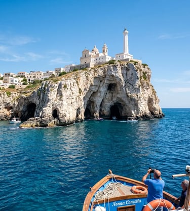 Tourists on boat exploring Santa Maria di Leuca sea caves under the lighthouse and basilica