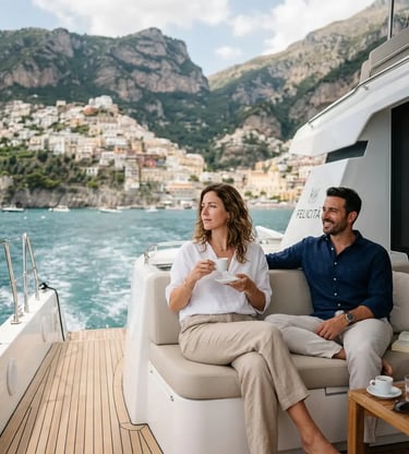 Couple relaxing with espresso on luxury catamaran deck along Amalfi coastline